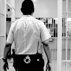 A prison guard walks through the hallways of a prison.