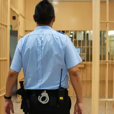 A prison guard walks through the hallways of a prison.