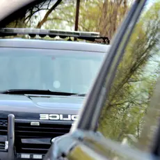 An image of a police SUV in another car's side mirror.