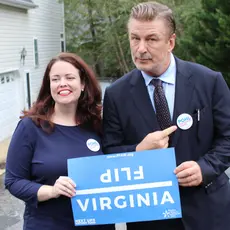 Actor Alec Baldwin and Senate Candidate Amanda Pohl holding a sign that says "Flip Virginia"