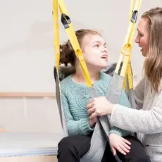 A child with disabilities and her caregiver