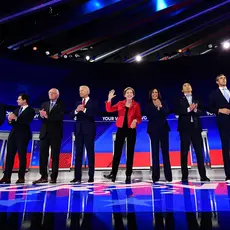 Democratic presidential candidates stand on a stage during a debate in 2019.