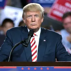 Donald Trump stands at a podium.