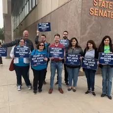 PFAW members and local activists rally outside of the Arizona Capitol to demand that Martha McSally support calling witnesses in impeachment