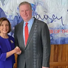 PFAW President Michael Keegan shakes hands with Nancy Pelosi