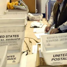 United States Postal Service boxes on table.