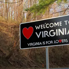 A street sign that reads "Welcome to Virginia, Virginia is for lovers"