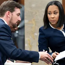 Fulton County District Attorney Fani Willis, right, talks with a member of her team during proceedings to seat a special purpose grand jury in Fulton County, Georgia, on May 2, 2022, to look into the actions of former President Donald Trump and his supporters who tried to overturn the results of the 2020 election. (AP Photo/Ben Gray, File)