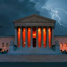 A scary image of the Supreme Court building with orange lights, lightning, and bats